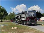 View larger image of A motorhome in a paved RV site at BIG RIG FRIENDLY RV RESORT image #4