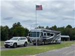 An American Flag in front of a motorhome at BIG RIG FRIENDLY RV RESORT - thumbnail
