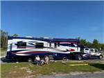 View larger image of A couple sitting in front of their RV at BIG RIG FRIENDLY RV RESORT image #8