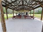 Picnic tables under the pavilion at EVERGREEN PARK & CAMPGROUND - thumbnail