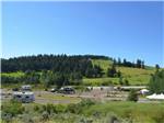 View larger image of Green hills with trees and RVs at SUMMIT RV RESORT image #11