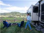 A couple relaxing outside their RV at ALPINE VALLEY RV RESORT - thumbnail