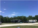 Row of campsites under clear blue sky at CROWS NEST RV RESORT - thumbnail