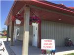 View larger image of Campground office with firewood sign in front at CROWS NEST RV RESORT image #8