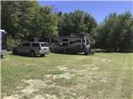 A motorhome parked in a grassy RV site at DREAMLAND RV PARKS - thumbnail