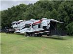 A toy hauler and truck parked on the grass at DREAMLAND RV PARKS - thumbnail