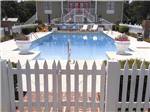 A white picket fence around the swimming pool area at PEBBLE HILL RV RESORT - thumbnail