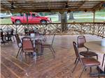 Chairs and tables under the pavilion at KELLER'S KOVE CABIN AND RV RESORT - thumbnail