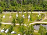 An aerial view of the grassy RV sites at AT EASE CAMPGROUND & MARINA - thumbnail