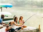 A family fishing from a pier at AT EASE CAMPGROUND & MARINA - thumbnail