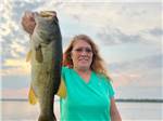 A woman holding a fish at AT EASE CAMPGROUND & MARINA - thumbnail