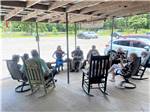 A group of people sitting around in a circle playing music at AT EASE CAMPGROUND & MARINA - thumbnail