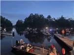 People on their boats at night at AT EASE CAMPGROUND & MARINA - thumbnail