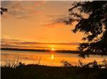 The beautiful sunset over the water at AT EASE CAMPGROUND & MARINA - thumbnail