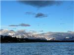 Snow-capped mountains beyond the lake at Duck Lake Campground - thumbnail