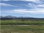 View of the mountains from a grassy field at Buffalo Calf Campground - thumbnail