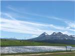 View of the mountains from the pond at Buffalo Calf Campground - thumbnail