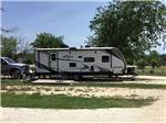 View larger image of Sandy campsite with a camper at OFF THE VINE RV PARK image #5