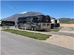 A row of paved pull thru sites at ROLLIN' HOME RV PARK - thumbnail