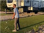 Golfer working on their chipping next to their RV - thumbnail