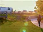 Two men walking with golf clubs at BUDA PLACE RV RESORT - thumbnail
