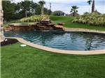 The swimming pool with a rock formation at BUDA PLACE RV RESORT - thumbnail
