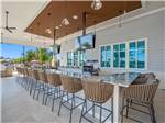 A group of stools around an outdoor bar at THE SURF RV RESORT - thumbnail