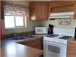 View larger image of Interior view of kitchen area at OUTPOST MOTEL CABINS AND RV PARK image #11