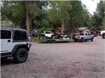 View larger image of Trucks and ATVs parked outside at OUTPOST MOTEL CABINS AND RV PARK image #12