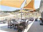 Outdoor dining tables and shade areas at BV OVERLOOK CAMP & LODGING - thumbnail