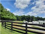 View larger image of A wooden fence on the hill above the RV sites at QUIET WOODS GREEN RIVER STABLES HORSE CAMP  RV PARK image #4