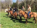 View larger image of A row of people on horseback at QUIET WOODS GREEN RIVER STABLES HORSE CAMP  RV PARK image #5