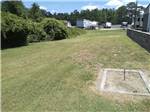 The horseshoe pits in a grassy field at BUTTON'S FAMILY CAMPGROUND - thumbnail
