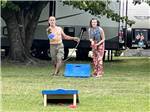 The man throwing the bean bag for corn hole at BUTTON'S FAMILY CAMPGROUND - thumbnail
