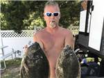 A man holding two flounders at BUTTON'S FAMILY CAMPGROUND - thumbnail