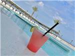 View larger image of A red drink with a lime by the pol at CAMP MARGARITAVILLE RV RESORT CRYSTAL BEACH image #3