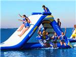 Kids enjoying the Aquaglide slide at COCONUT COVE RV RESORT BY RJOURNEY - thumbnail