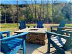 Six chairs and a fire pit at BULL CREEK RV PARK - thumbnail