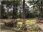 Nicely landscaped area with fence at MAJESTIC PINES RV RESORT - thumbnail