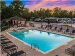 View of pool with beautiful sky at MAJESTIC PINES RV RESORT - thumbnail