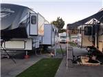A fifth wheel trailer and trailer with it's slideouts out at CENTER POINT RV PARK - thumbnail