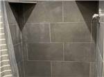 Inside of the modern tiled shower stall at CENTER POINT RV PARK - thumbnail