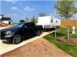 View larger image of Camper and truck in campsite at PETEYS RV RESORT  MARINA image #4