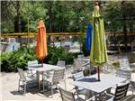 Tables and umbrellas next to the swimming pool at ELKHART RV RESORT BY RJOURNEY - thumbnail