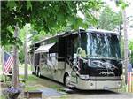 Class A motorhome in a gravel site at ELKHART RV RESORT BY RJOURNEY - thumbnail