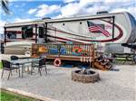 Close-up of RV site with deck and fire pit at PORT O'CONNOR RV PARK - thumbnail