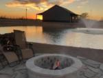 A fire pit with pond in the background - thumbnail