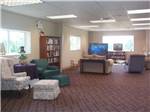 Lounge area with books and TV at TOPSAIL SOUND RV PARK - thumbnail