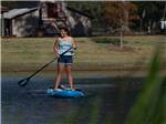 A young woman paddling on the water at GULF SHORES RV RESORT - thumbnail
