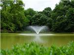 A fountain in the pond at THE HILL TOP AT BRENHAM RV RESORT - thumbnail